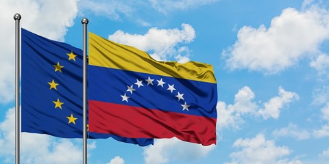 European Union and Venezuela flag waving in the wind against white cloudy blue sky together. Diplomacy concept, international relations.