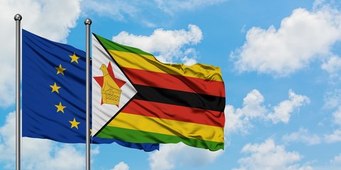 European Union and Zimbabwe flag waving in the wind against white cloudy blue sky together. Diplomacy concept, international relations.