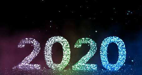 The numbers 2020 are written from sparkles. Template for a festive New Year card from beautiful bokeh. Happy New Year 2020.