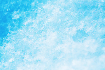 Winter christmas background. Snowflakes in the soft white snow. Winter background.