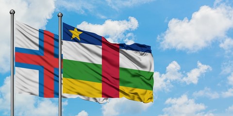 Faroe Islands and Central African Republic flag waving in the wind against white cloudy blue sky together. Diplomacy concept, international relations.
