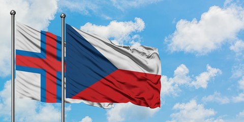 Faroe Islands and Czech Republic flag waving in the wind against white cloudy blue sky together. Diplomacy concept, international relations.