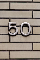 metal number 50 on tile wall