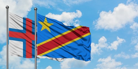 Faroe Islands and Congo flag waving in the wind against white cloudy blue sky together. Diplomacy concept, international relations.