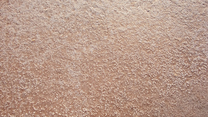 Pink salt crystals background; salt bed surface where crystallization is forming naturally when...