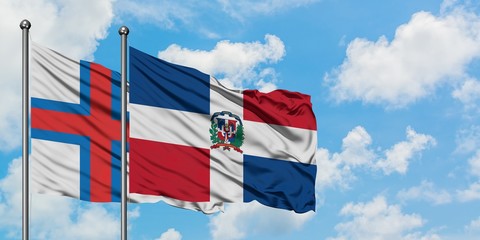 Faroe Islands and Dominican Republic flag waving in the wind against white cloudy blue sky together. Diplomacy concept, international relations.