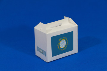 South Dakota flag on white box with barcode and the color of state flag on blue background. The concept of export trading from South Dakota.