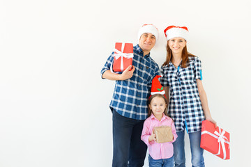 Holidays and celebration concept - Happy family with Christmas presents on white background with copy space