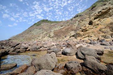 the rocky coast of the bay Cantareddi, near Castelsardo, in Sardinia, on a summer sunny day