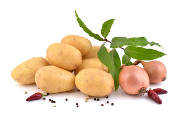 Raw potatoes, fresh laurel, onions  and pepper isolated on a white background. 