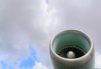 Aircraft jet turbine against a blue sky with clouds. Travel and business trips by plane.