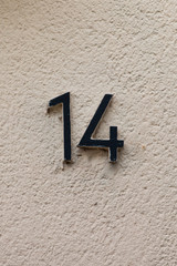 black number 14 on white wall