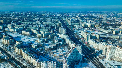 Naklejka na ściany i meble Top view of city in winter at sunset on sky background. Aerial drone photography concept. Kishinev, Republic of Moldova.