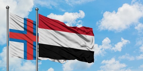 Faroe Islands and Yemen flag waving in the wind against white cloudy blue sky together. Diplomacy concept, international relations.