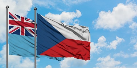 Fiji and Czech Republic flag waving in the wind against white cloudy blue sky together. Diplomacy concept, international relations.