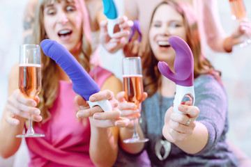 Women showing sex toys they bought at a dildo party - obrazy, fototapety, plakaty