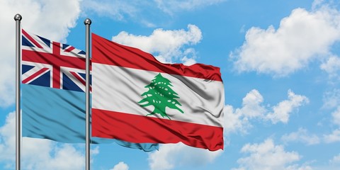 Fiji and Lebanon flag waving in the wind against white cloudy blue sky together. Diplomacy concept, international relations.