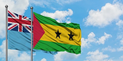 Fiji and Sao Tome And Principe flag waving in the wind against white cloudy blue sky together. Diplomacy concept, international relations.