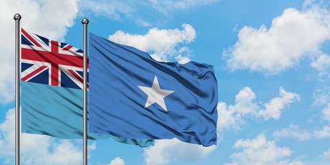 Fiji and Somalia flag waving in the wind against white cloudy blue sky together. Diplomacy concept, international relations.