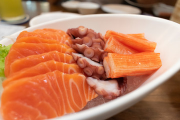 Salmon, squid and crab stick sashimi.