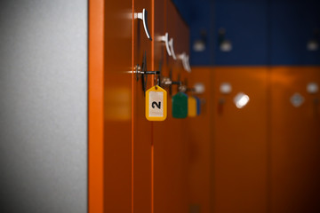 the locker room is empty with bright lockers