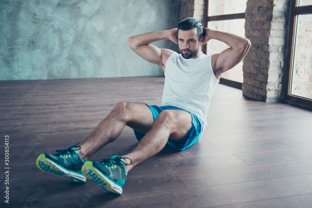 Wall mural photo of macho sportsman guy doing static sit ups sitting floor determined person sportswear tank-to