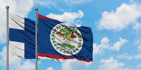 Finland and Belize flag waving in the wind against white cloudy blue sky together. Diplomacy...