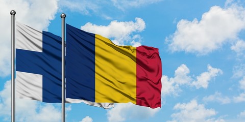 Finland and Chad flag waving in the wind against white cloudy blue sky together. Diplomacy concept, international relations.