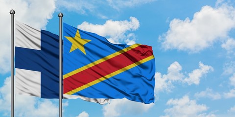 Finland and Congo flag waving in the wind against white cloudy blue sky together. Diplomacy concept, international relations.