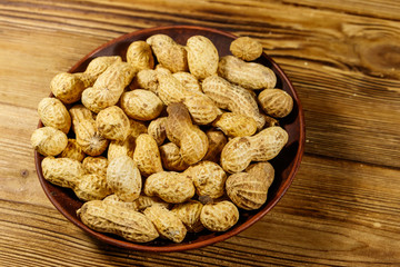 Peanuts in nutshell on a wooden table