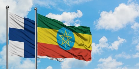Finland and Ethiopia flag waving in the wind against white cloudy blue sky together. Diplomacy concept, international relations.