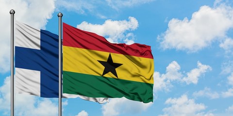 Finland and Ghana flag waving in the wind against white cloudy blue sky together. Diplomacy concept, international relations.