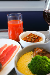 photo of Food served on board of business class airplane on the table