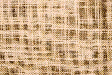 Rough hessian background with flecks of varying colors of beige and brown. with copy space. office desk concept, Hessian sackcloth burlap woven texture background.