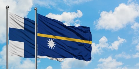 Finland and Nauru flag waving in the wind against white cloudy blue sky together. Diplomacy...