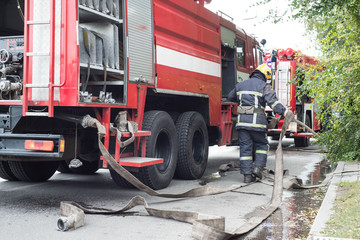 The fire brigade works at a source of ignition in a residential building.