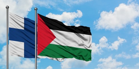 Finland and Palestine flag waving in the wind against white cloudy blue sky together. Diplomacy concept, international relations.