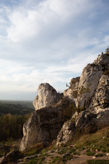 Fototapeta na wymiar Vertical mountain landscape of limestone cliffs against a blue sky. The Zborow Massif in Central Poland on the Krakow-Czestochowa Upland