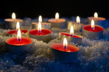 Many burning tea lights