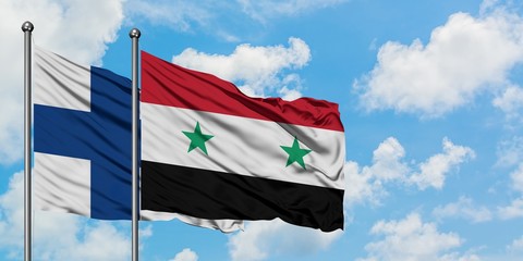 Finland and Syria flag waving in the wind against white cloudy blue sky together. Diplomacy...