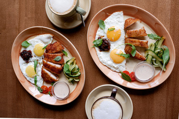 Fried eggs with chicken breast breaded. breakfast
