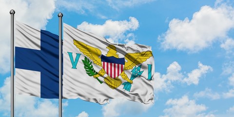 Finland and United States Virgin Islands flag waving in the wind against white cloudy blue sky together. Diplomacy concept, international relations.