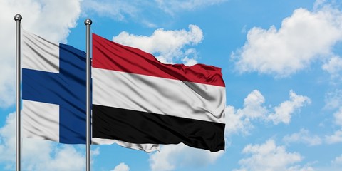 Finland and Yemen flag waving in the wind against white cloudy blue sky together. Diplomacy concept, international relations.