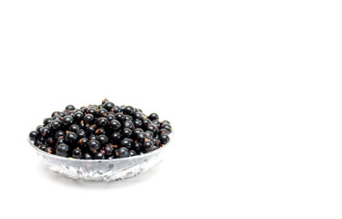 Black currant on a plate. Background. Photo.