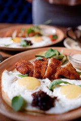 Fried eggs with chicken breast breaded. breakfast