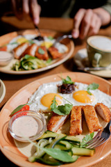 Fried eggs with chicken breast breaded. breakfast