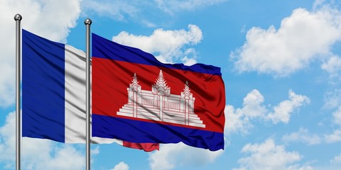 France and Cambodia flag waving in the wind against white cloudy blue sky together. Diplomacy concept, international relations.