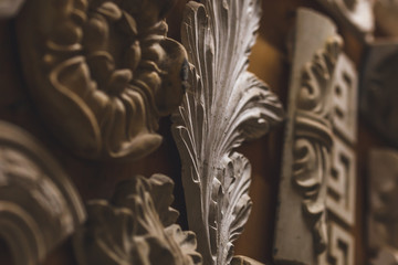 Plaster architectural elements on the wall in the sculpture ctudio. Close-up background.