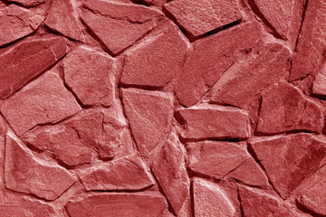 Wall made of old stones in red tone.