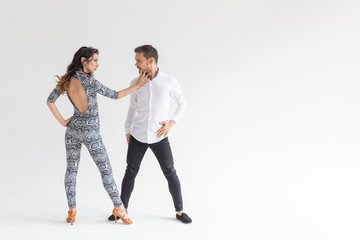 Passionate couple dancing social danse kizomba or bachata or semba or taraxia on white background with copy space